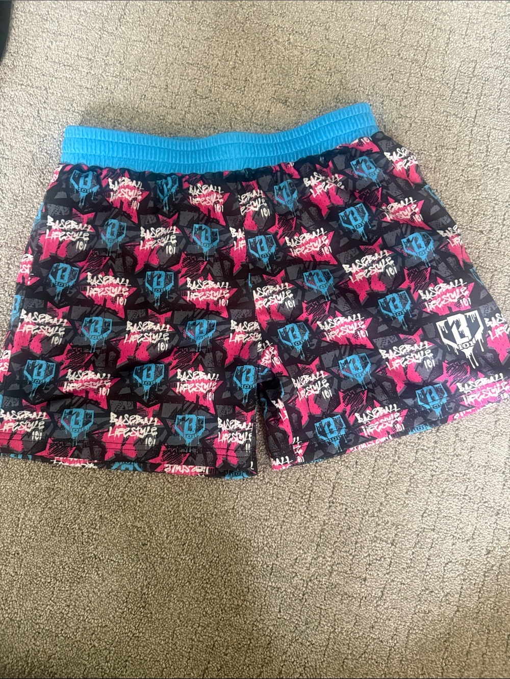 Kids Black Graphic Swim Shorts with Blue Waistband and Pink Accents
